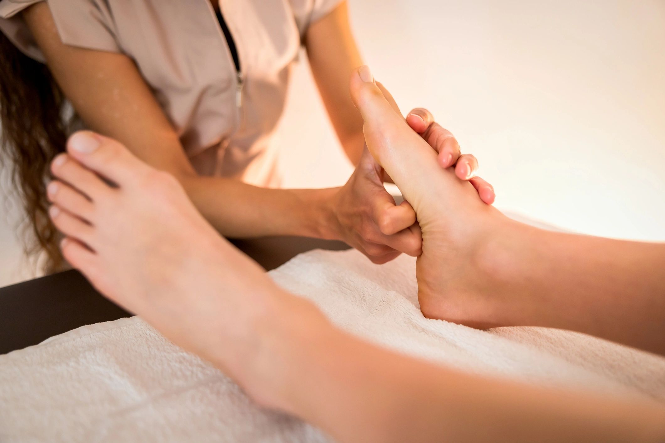 Reflexology foot massage in a calm treatment setting